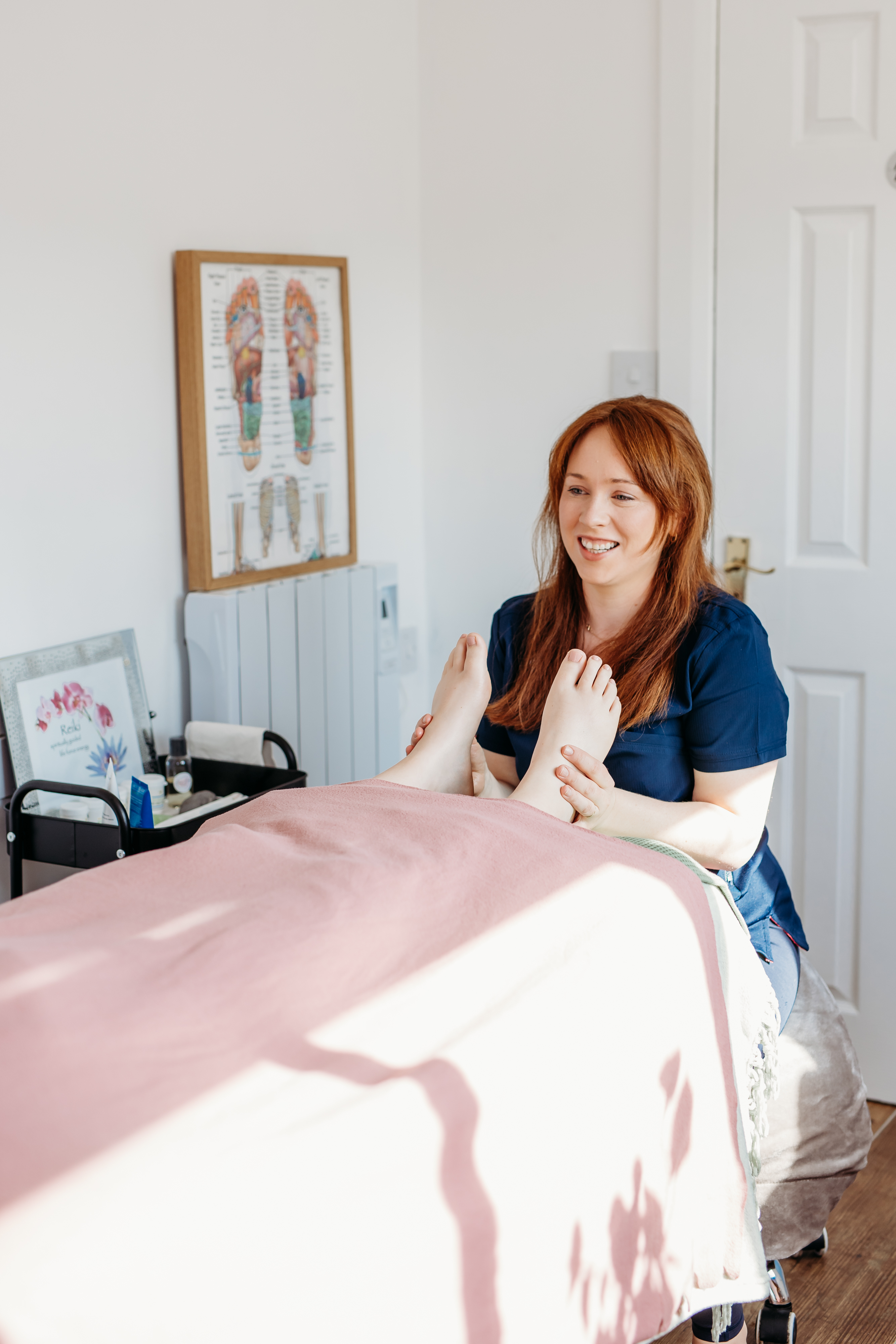 Grainne carrying out reflexology on a client at 8ráBeo Holistics in Claregalway Galway